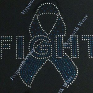 May include: A blue and white rhinestone design of a ribbon with the word "FIGHT" in rhinestones.