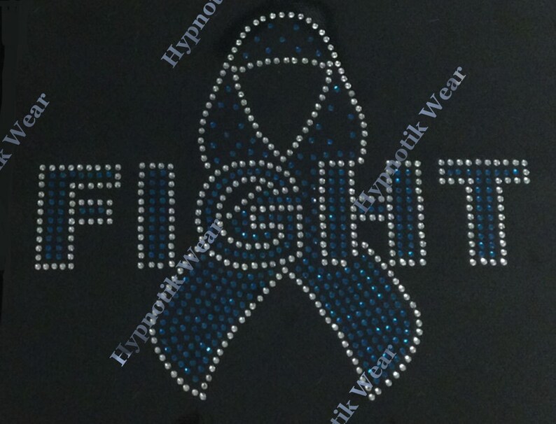 May include: A blue and white rhinestone design of a ribbon with the word "FIGHT" in rhinestones.
