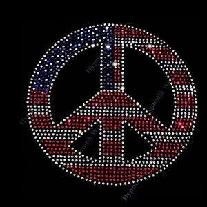 May include: A peace sign made of rhinestones in the colors of the American flag. The peace sign is red, white, and blue.