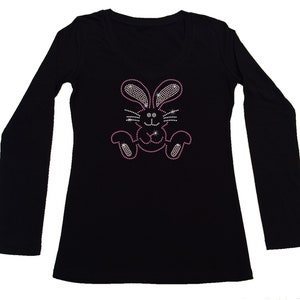May include: Black long-sleeved shirt with a pink rhinestone bunny design.