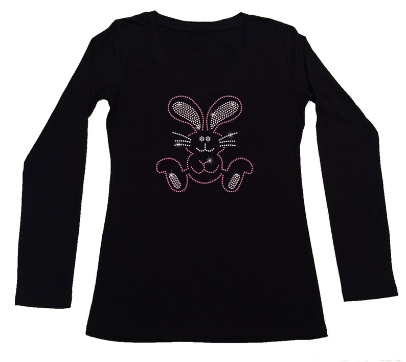 May include: Black long-sleeved shirt with a pink rhinestone bunny design.