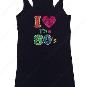 May include: A black tank top with a rhinestone design that says "I &hearts; The 80's". The heart is pink and the numbers are rainbow colored.