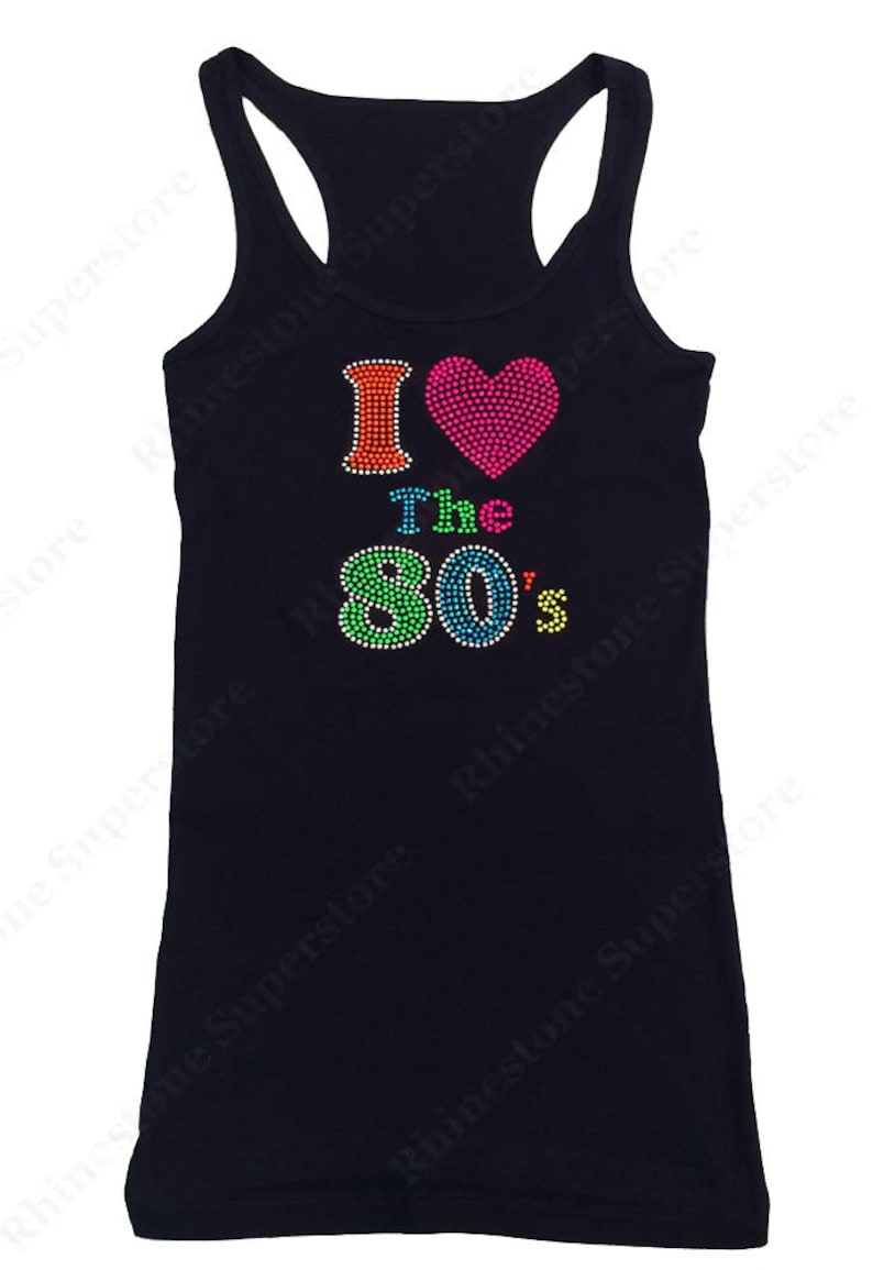 May include: A black tank top with a rhinestone design that says "I &hearts; The 80's". The heart is pink and the numbers are rainbow colored.