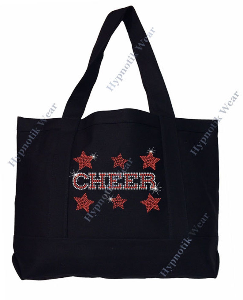 May include: Black canvas tote bag with the word "CHEER" in red and silver rhinestones. The word is surrounded by six red and silver rhinestone stars.