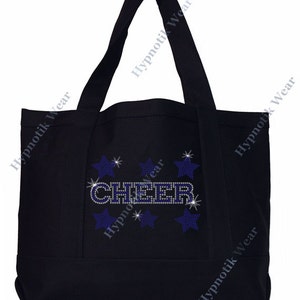 May include: Black canvas tote bag with the word "CHEER" in blue rhinestones and surrounded by silver glitter stars.