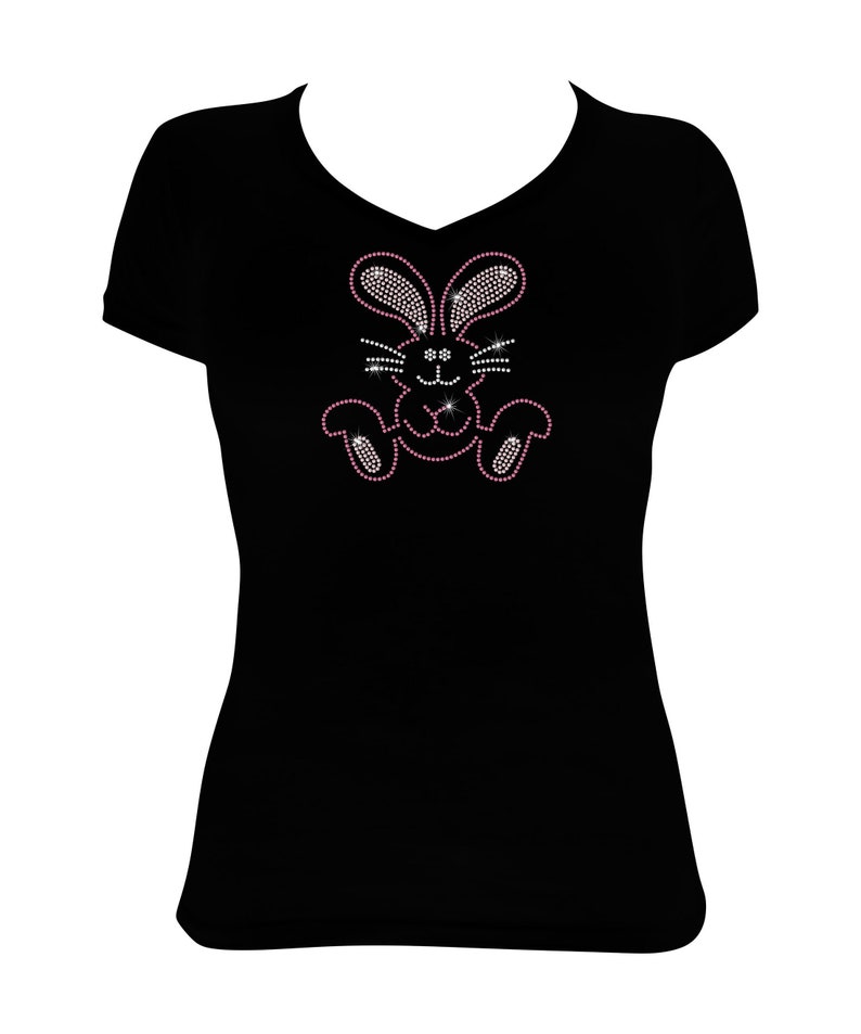 May include: Black t-shirt with a pink rhinestone bunny design.