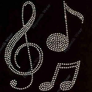 May include: A set of three rhinestone musical note designs. The designs are a treble clef, a single note, and a set of two notes. The rhinestones are white and are arranged in a pattern to create the shape of the notes.