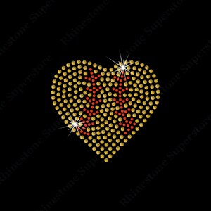May include: A gold heart-shaped rhinestone design with red stars in the center.