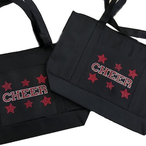 May include: Two black tote bags with red star and rhinestone accents. The larger bag has the word "CHEER" in rhinestones.