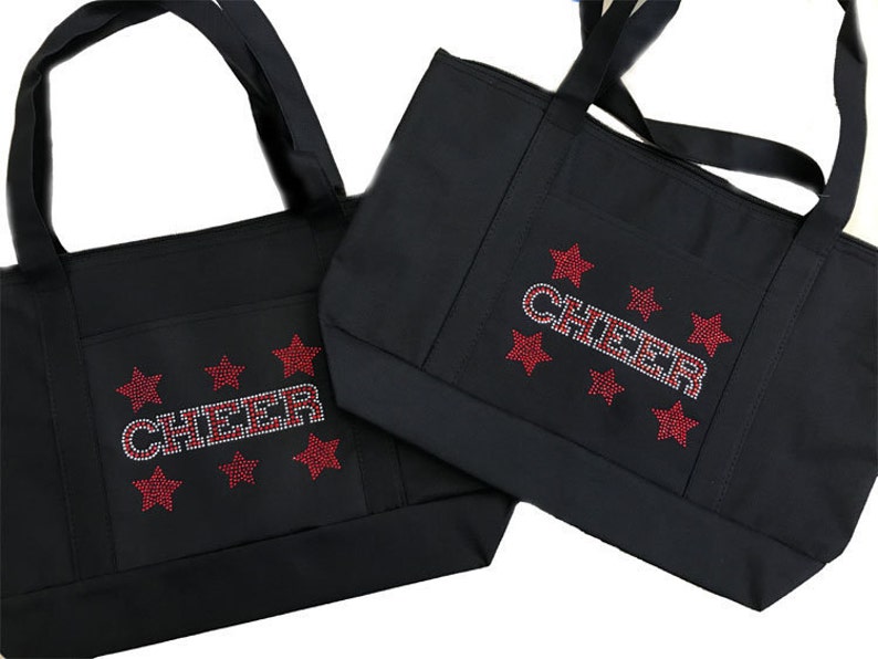 May include: Two black tote bags with red star and rhinestone accents. The larger bag has the word "CHEER" in rhinestones.