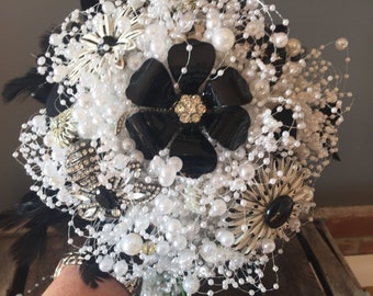 Black and white wedding bouquet with vintage brooches and pearls with feather collar. Bridal bouquet. Vintage bouquet.