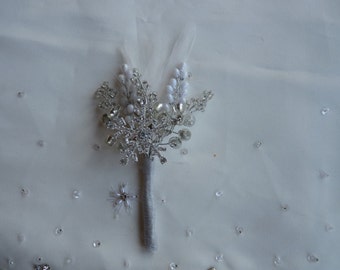 Boutonniere in silver with  large diamante snowflake and silver, white and clear crystals and feathers. Winter wedding. Christmas wedding