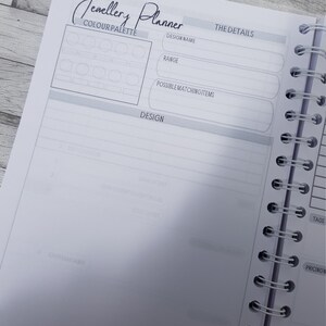 May include: A blank page from a jewelry planner with a color palette section, design details, and a design section. The page has the text "Jewelry Planner" at the top.