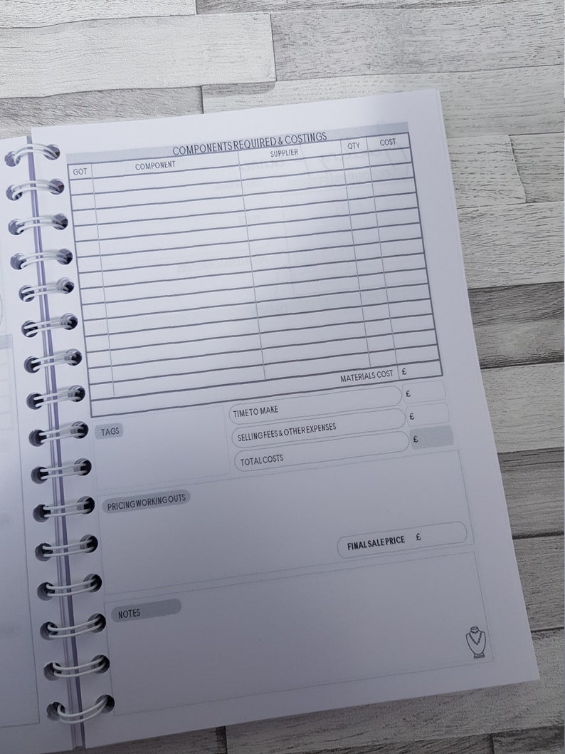 May include: A white and gray planner with a section for listing components, suppliers, quantities, and costs. There are also sections for time to make, selling fees, total costs, materials cost, and final sale price.
