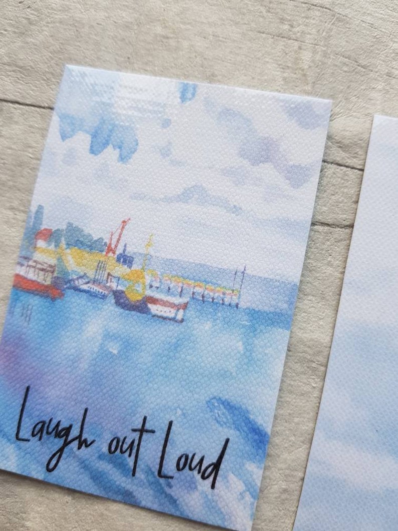 May include: A watercolour painting of a harbour scene with boats and a crane. The sky is blue with white clouds. The text "Laugh out Loud" is written in black at the bottom of the image.