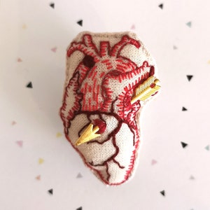 Anatomical heart brooch with and without cupids&#39; arrow