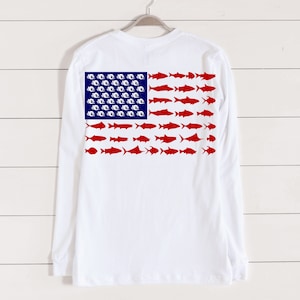 May include: White long-sleeve t-shirt with a red, white, and blue American flag design featuring fish silhouettes.