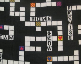 May include: Black fabric with a white crossword grid design. The crossword includes words like HOME, TEAM, GROW, and PROMISE. Colorful accents include stars, hearts, and striped squares. The overall theme is positive and motivational.