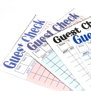 May include: A stack of rectangular paper guest checks arranged in a fan pattern. Each check features the text Guest Check at the top, with columns for Date and Table, and a section labeled APPT - SOUP/SALAD followed by blank horizontal lines.