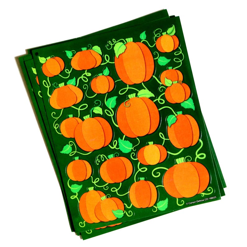 May include: A stack of dark green sheets featuring a repeating pattern of orange pumpkins with light green leaves and swirling vines. The bottom right corner of the sheets displays the printed text Carson-Dellosa CD-168025.