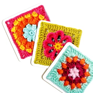 May include: Close-up of three colorful crochet squares with floral designs. The squares feature vibrant colors like pink, orange, yellow, green, and blue. Each square is a different color combination, showcasing the intricate crochet work.