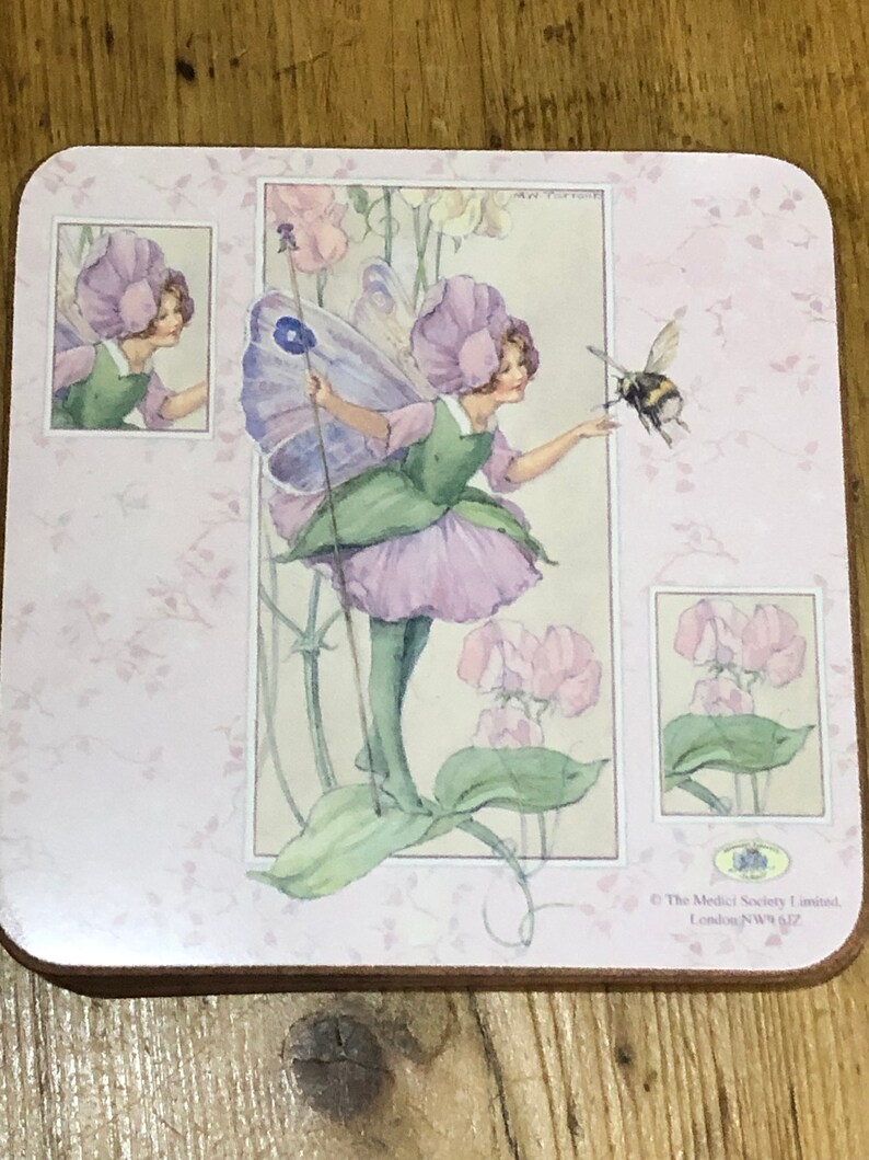 May include: A pink and green fairy with a flower crown and wings, holding a wand, stands in a field of pink flowers. A bee flies nearby. The image is from The Medici Society Limited, London, NW11 7JZ.