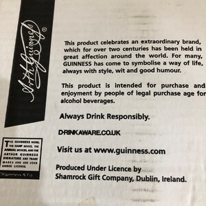 May include: A white box with black text that reads "This product celebrates an extraordinary brand, which for over two centuries has been held in great affection around the world. For many, GUINNESS has come to symbolise a way of life, always with style, wit and good humour. This product is intended for purchase and enjoyment by people of legal purchase age for alcohol beverages. Always Drink Responsibly. DRINKAWARE.CO.UK Visit us at www.guinness.com Produced Under Licence by Shamrock Gift Company, Dublin, Ireland."