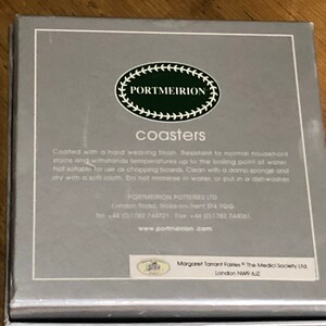 May include: A silver box with a white label that says "PORTMEIRION coasters". The label also includes instructions for caring for the coasters. The box is for coasters that are resistant to normal household stains and can withstand temperatures up to the boiling point of water.