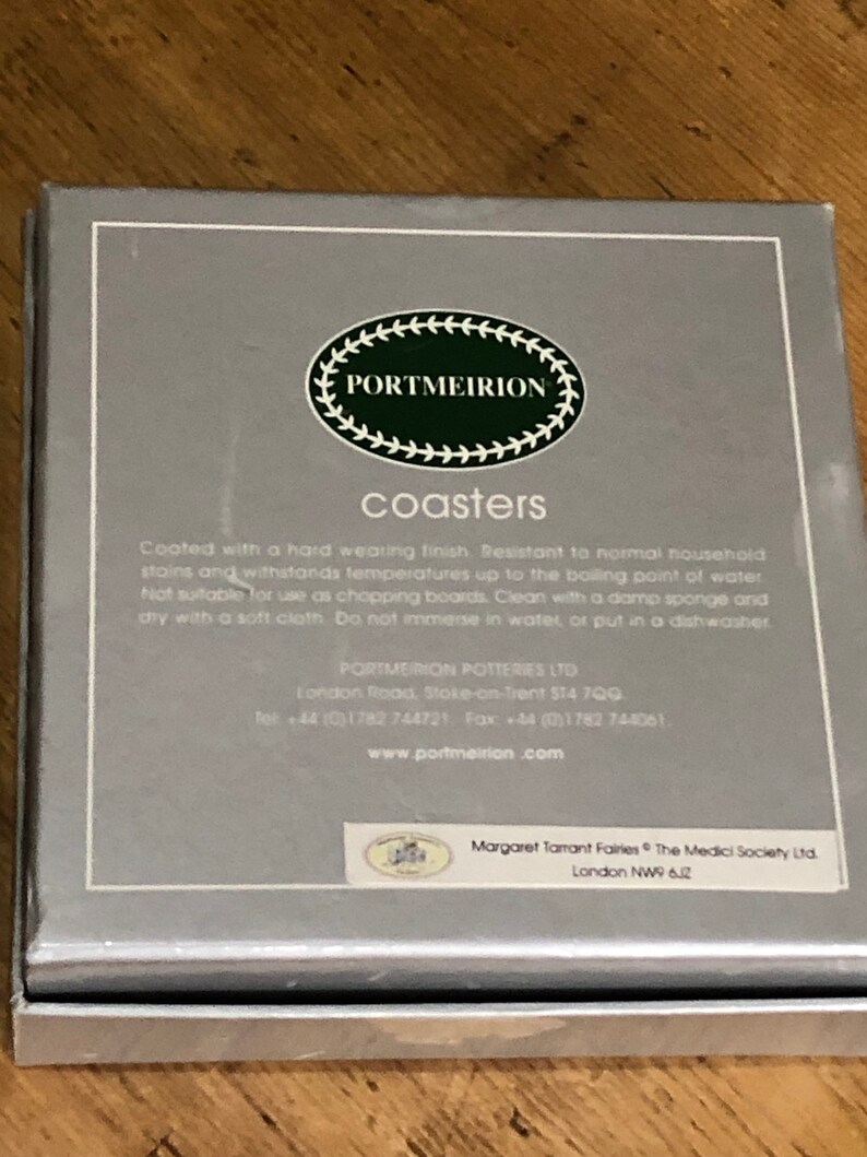 May include: A silver box with a white label that says "PORTMEIRION coasters". The label also includes instructions for caring for the coasters. The box is for coasters that are resistant to normal household stains and can withstand temperatures up to the boiling point of water.