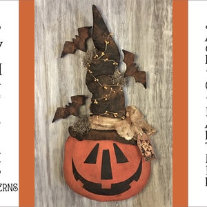 May include: A handmade pumpkin-shaped Jack-O-Lantern with a witch's hat on top. The hat is brown and has a green vine with yellow berries wrapped around it. The pumpkin is orange with a black painted face. The background is a rustic wooden surface. "Sew Many Prims Patterns" is written on the left side of the image and "Jack-O-Lantern" is written on the right side of the image.