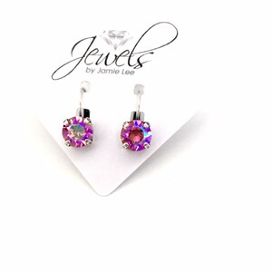 May include: A pair of silver earrings with iridescent purple gemstones. The earrings are on a white card with the text "Jewels by Jamie Lee".