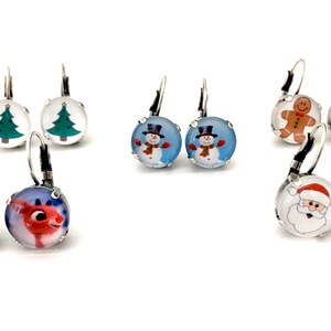 May include: Assortment of Christmas themed dangle earrings. The earrings feature a variety of designs including a Christmas tree, snowman, gingerbread man, reindeer, and Santa Claus. The earrings are silver in color and have a hook closure.