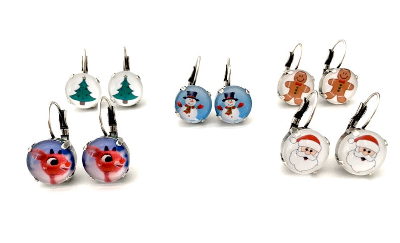 May include: Assortment of Christmas themed dangle earrings. The earrings feature a variety of designs including a Christmas tree, snowman, gingerbread man, reindeer, and Santa Claus. The earrings are silver in color and have a hook closure.
