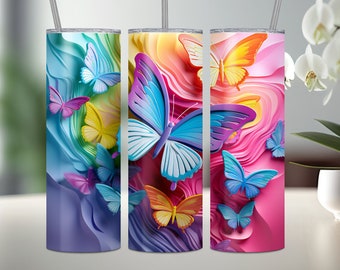 May include: Three stainless steel tumblers with colorful butterfly designs. The tumblers are decorated with a rainbow of colors and feature butterflies in various shades of blue, pink, yellow, and purple.