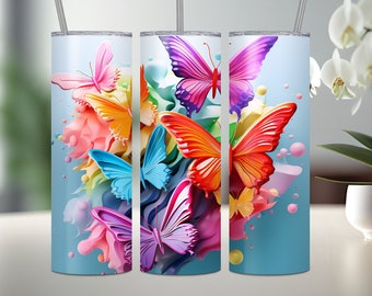 May include: Three stainless steel tumblers with colorful butterfly designs. The butterflies are layered on top of each other and have a 3D effect. The tumblers are a light blue color and have a white lid.