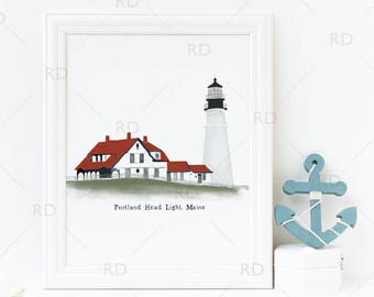 May include: A framed print of the Portland Head Light in Maine. The artwork depicts the lighthouse and adjacent buildings with red roofs and white walls. The text "Portland Head Light, Maine" is below the image. A decorative blue anchor is next to the frame.