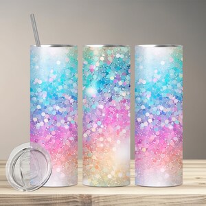 May include: Three stainless steel tumblers with a rainbow glitter design. The tumblers have a clear lid and a straw.