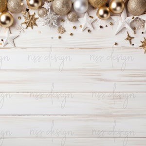 May include: Whitewashed wood background with a border of gold and silver ornaments, including stars, baubles, and snowflakes.