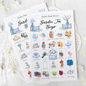 May include: A blue and white garden tea party bingo card with images of teacups, flowers, cupcakes, and other tea party items. The card says "Giselle's Bridal Shower Garden Tea Bingo" at the top.