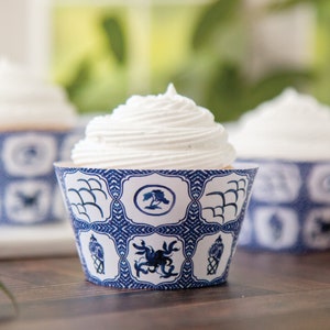 May include: Blue and white cupcake liners with a traditional Chinese design. The liners feature a repeating pattern of birds, waves, and flowers.