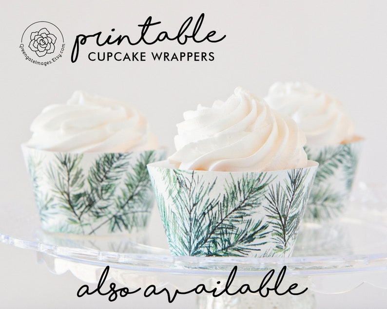 May include: Three cupcakes with white frosting in decorative cupcake wrappers. The wrappers have a green and white pine needle design. The text "printable CUPCAKE WRAPPERS" is displayed above the cupcakes.