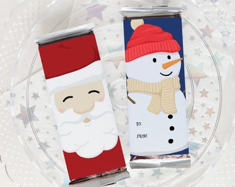 May include: Two Christmas-themed chocolate bar wrappers. One features a smiling Santa Claus with a red hat and white beard. The other features a snowman with a red hat, a tan scarf, and black buttons. Both wrappers have a space for "To:" and "From:" text.
