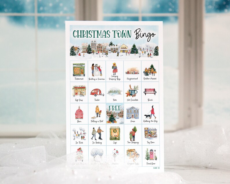 May include: A Christmas Town Bingo card with a watercolor illustration of a winter town scene. The card has 25 squares with different images, including a snowman, a Christmas tree, a gift shop, a hot chocolate stand, and a walking dog. The free space is in the center of the card.