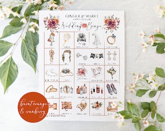 May include: A printable wedding bingo card with a floral design in shades of burnt orange and cranberry. The card features images of common wedding items such as a cake, rings, a bouquet, and a wedding dress. The text "Ginger & Mario" and "Wedding Bingo" is printed at the top of the card.
