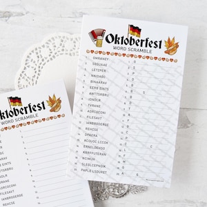 May include: Two white Oktoberfest Word Scramble game sheets. Each sheet has a title with a beer stein, pretzel, and German flag graphic. The sheets have a list of scrambled words and corresponding letter blanks.