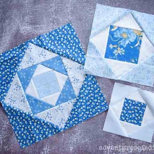 May include: Three blue and white fabric squares with different patterns. The squares are arranged in a row on a grey surface. The square on the left is the largest and has a starburst pattern. The middle square has a floral pattern and the square on the right has a simple square pattern.