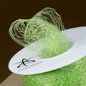 May include: A spool of lime green sheer ribbon with a white label that says "Club Green".