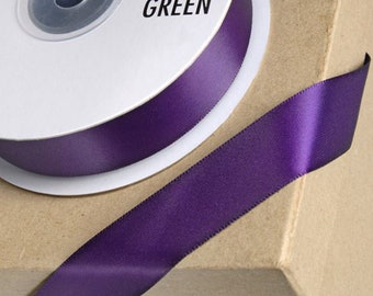 May include: A spool of purple satin ribbon with the text "CLUB GREEN" printed on the label.