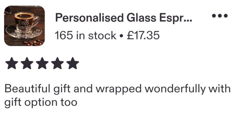 May include: A clear glass espresso cup and matching saucer filled with dark coffee. The glass features white text that reads Dad's Espresso. The set is displayed with scattered roasted coffee beans on a dark wooden surface.