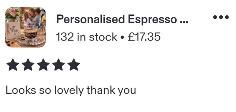 May include: A clear glass espresso cup featuring the word espresso printed in white script lettering on the front. The cup sits on a matching glass saucer, and a small wooden sign with the text for Mum is visible in the background.